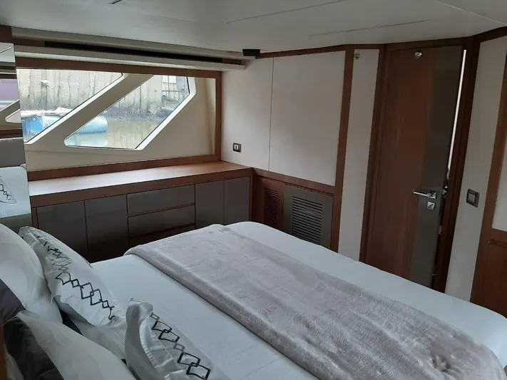  Yacht Photos Pics Luxurious bedroom interior of 2020 Intermarine 80 yacht with modern design and large window.