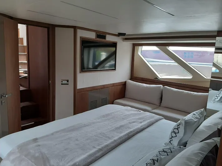  Yacht Photos Pics Luxurious bedroom interior of 2020 Intermarine 80 yacht with modern decor and large windows.