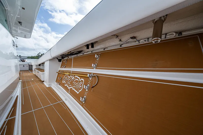  Yacht Photos Pics 2022 HCB 53 boat deck with brown flooring and white accents under a cloudy sky.