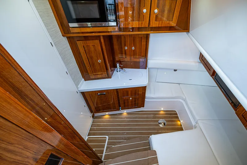  Yacht Photos Pics Luxurious interior of 2022 HCB 53 yacht with wood cabinetry and modern amenities.