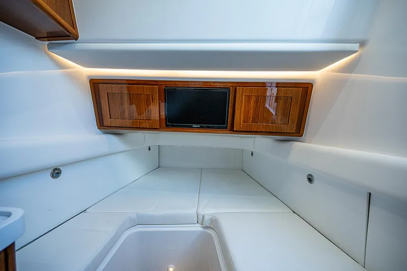  Yacht Photos Pics Luxurious interior cabin of 2022 HCB 53 boat with wood accents and modern lighting.