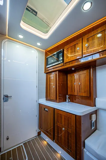  Yacht Photos Pics Luxurious 2022 HCB 53 yacht interior with wooden cabinetry and modern lighting.