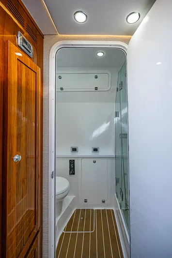  Yacht Photos Pics Luxurious 2022 HCB 53 yacht bathroom with modern fixtures and wood accents.