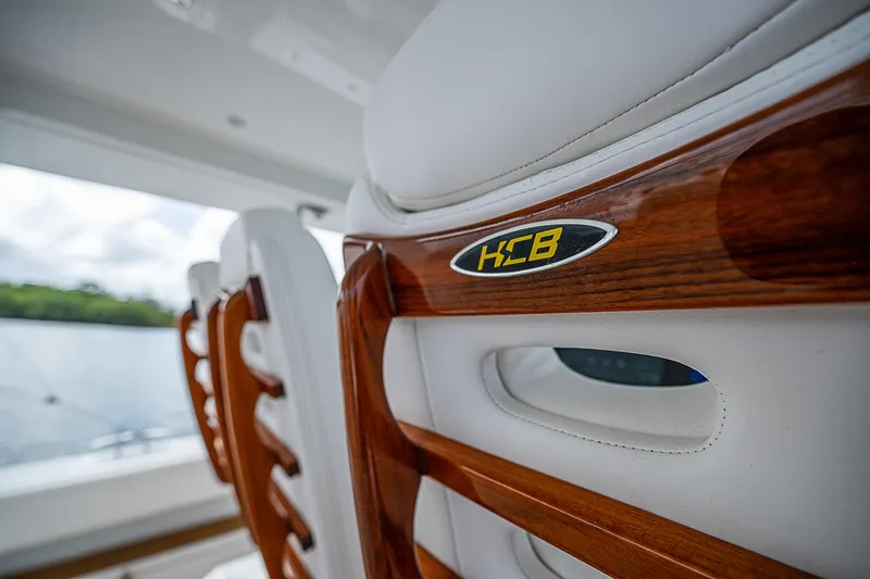  Yacht Photos Pics Luxury seating on 2022 HCB 53 boat with wooden accents.
