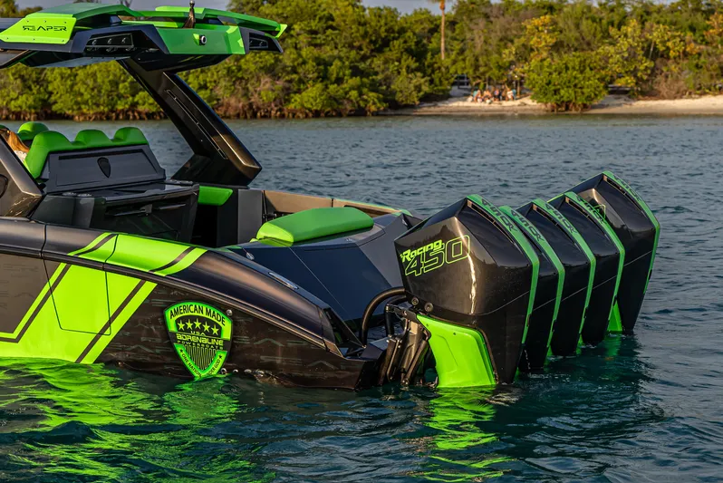  Yacht Photos Pics 2024 Adrenaline Reaper boat with vibrant green accents and powerful engines on a serene water backdrop.