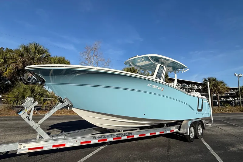  Yacht Photos Pics 2024 Sea Fox 288 Commander boat on trailer, parked outdoors under clear blue sky.