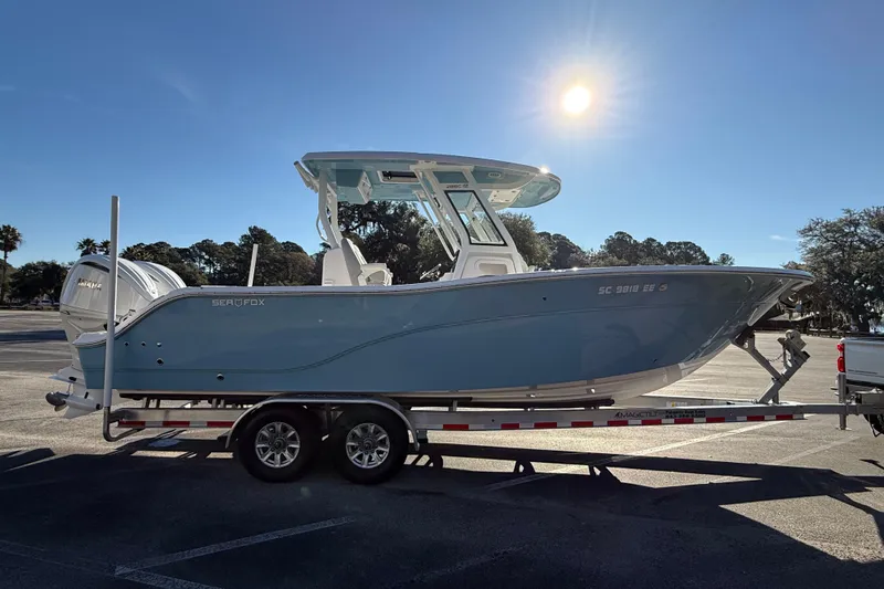  Yacht Photos Pics 2024 Sea Fox 288 Commander boat on trailer under bright sunlit sky.