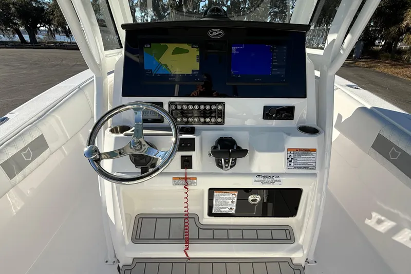  Yacht Photos Pics 2024 Sea Fox 288 Commander boat dashboard with steering wheel and navigation screens.