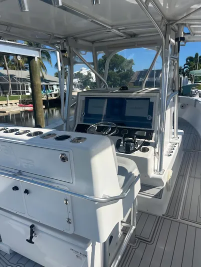  Yacht Photos Pics 2006 SeaVee 340 boat cockpit with dual screens and steering wheel, docked in a marina.
