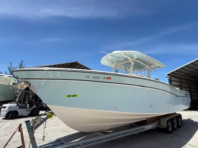 336-311 Brokerage Ron Yacht Photos Pics 2018 Grady-White Canyon 336 boat on trailer, for sale, under clear blue sky.
