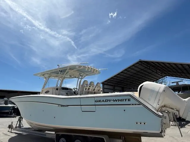 336-311 Brokerage Ron Yacht Photos Pics 2018 Grady-White Canyon 336 boat on trailer under clear blue sky.