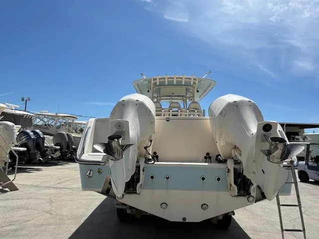 336-311 Brokerage Ron Yacht Photos Pics 2018 Grady-White Canyon 336 boat with dual outboard engines, docked under clear blue sky.