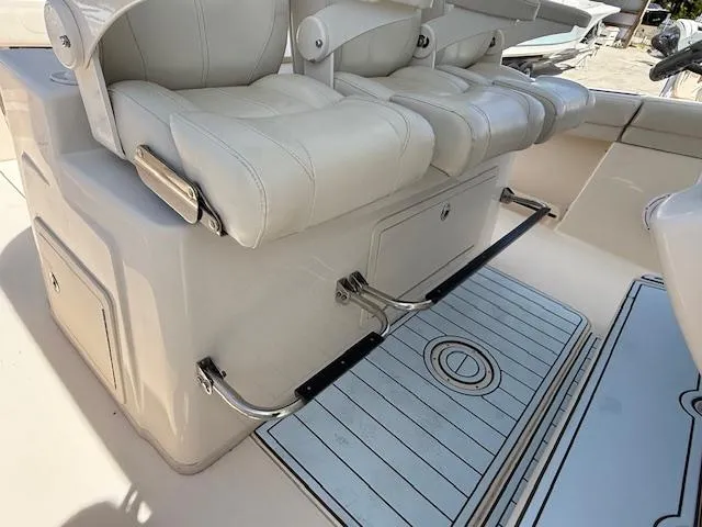 336-311 Brokerage Ron Yacht Photos Pics 2018 Grady-White Canyon 336 boat seating area with cushioned seats and storage.