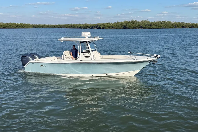  Yacht Photos Pics 2021 Sea Hunt Gamefish 30 boat cruising on calm waters under a clear sky.