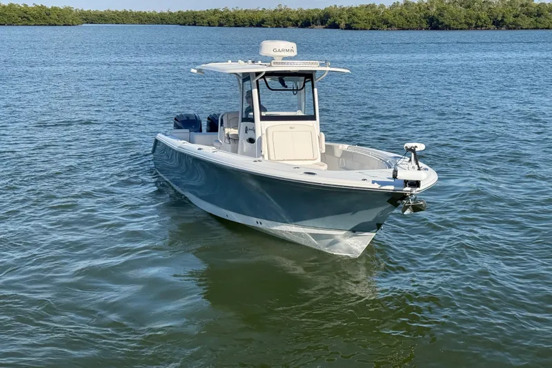  Yacht Photos Pics 2021 Sea Hunt Gamefish 30 boat on calm water, featuring forward seating.