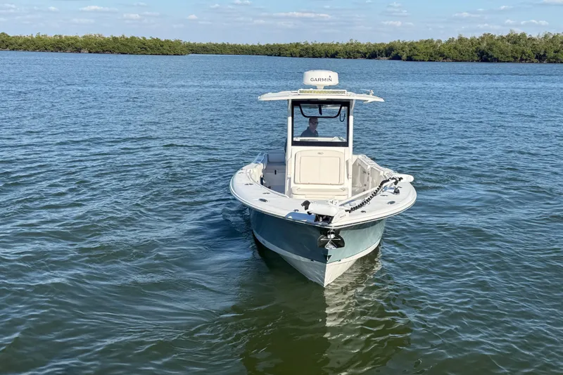  Yacht Photos Pics 2021 Sea Hunt Gamefish 30 boat on calm water, featuring forward seating.