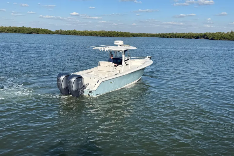  Yacht Photos Pics 2021 Sea Hunt Gamefish 30 boat cruising on calm water under a clear sky.