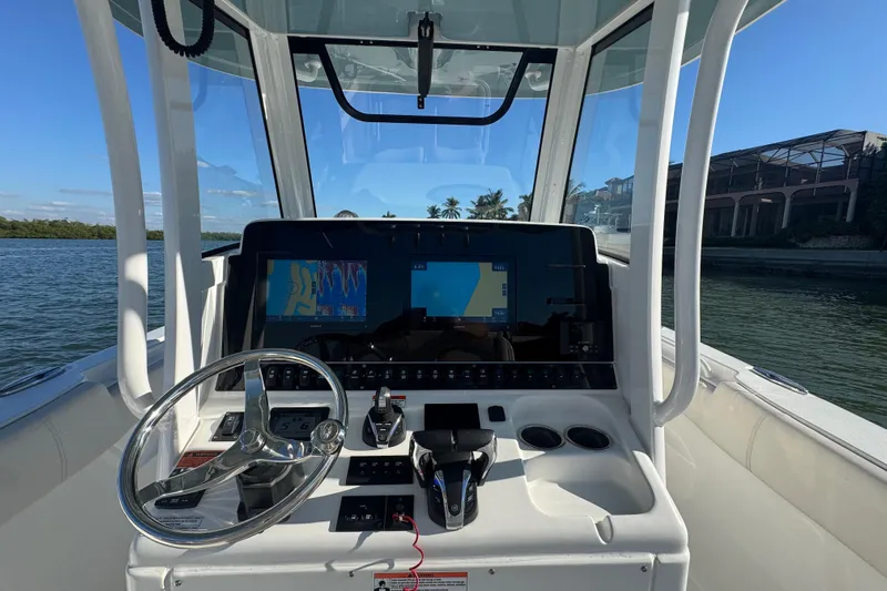  Yacht Photos Pics 2021 Sea Hunt Gamefish 30 helm with modern navigation displays and steering wheel.