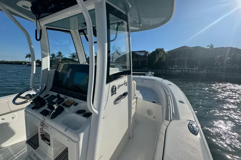  Yacht Photos Pics 2021 Sea Hunt Gamefish 30 boat with forward seating, docked on a sunny day.