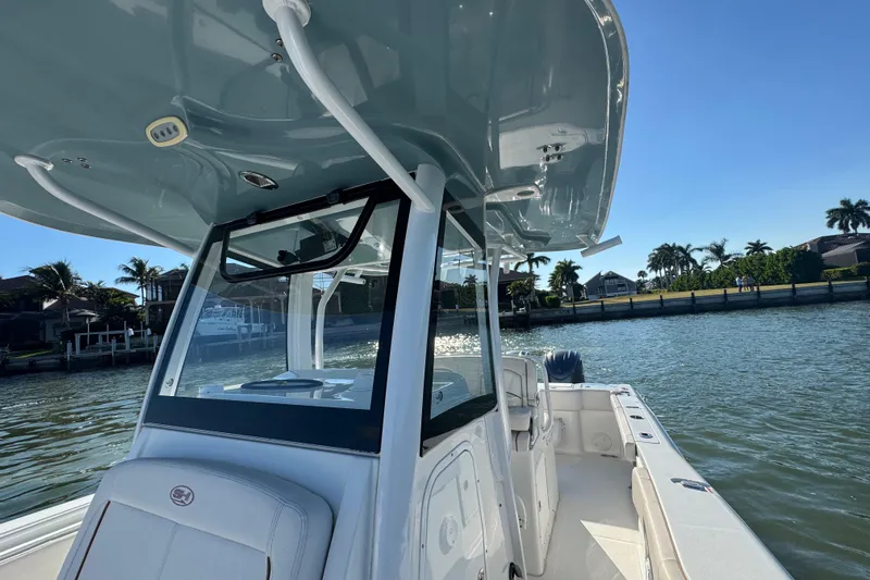  Yacht Photos Pics 2021 Sea Hunt Gamefish 30 boat with forward seating on a sunny day by the water.