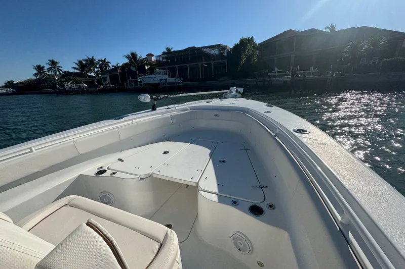  Yacht Photos Pics 2021 Sea Hunt Gamefish 30 boat with forward seating, docked near waterfront homes.