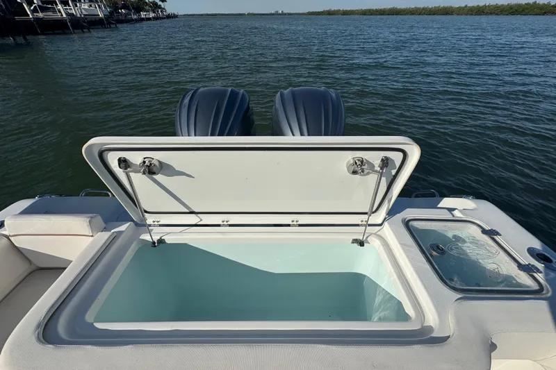  Yacht Photos Pics 2021 Sea Hunt Gamefish 30 boat with open storage compartment and twin engines on water.