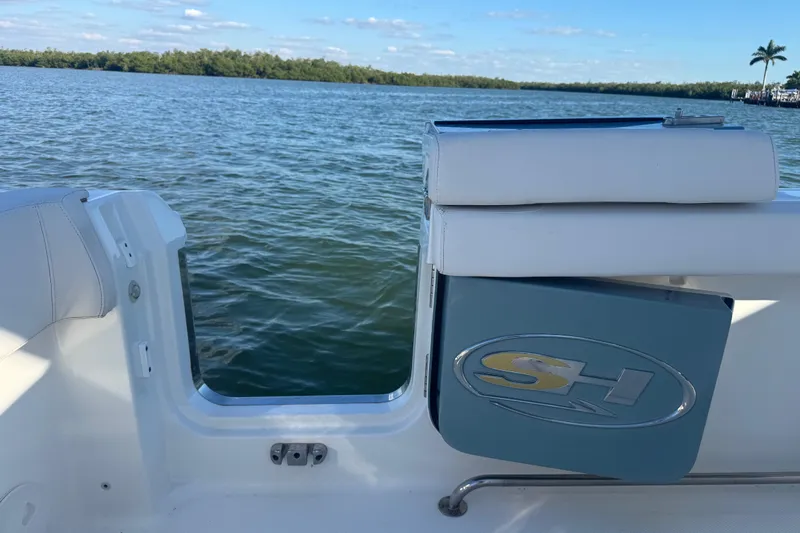  Yacht Photos Pics 2021 Sea Hunt Gamefish 30 boat with forward seating, docked by a scenic waterway.