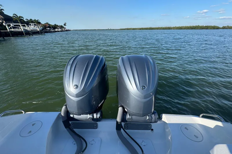  Yacht Photos Pics 2021 Sea Hunt Gamefish 30 boat with dual outboard motors on a calm lake.