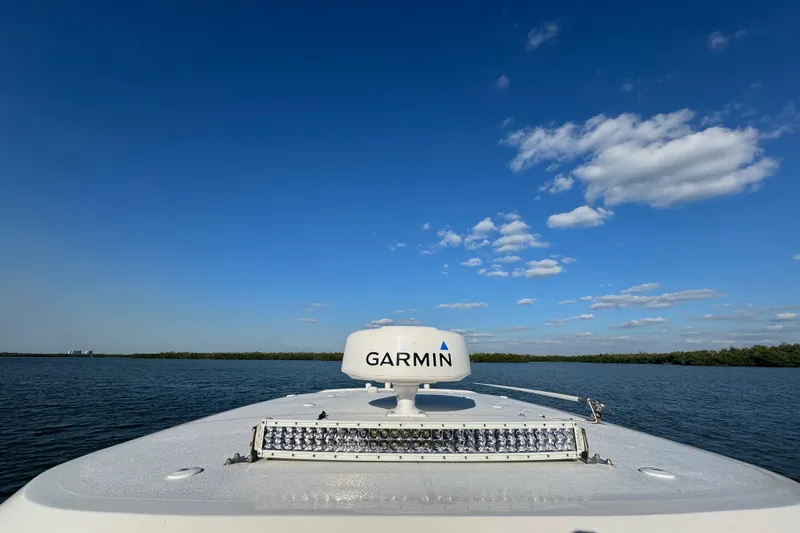  Yacht Photos Pics 2021 Sea Hunt Gamefish 30 boat with Garmin equipment on calm water under blue sky.