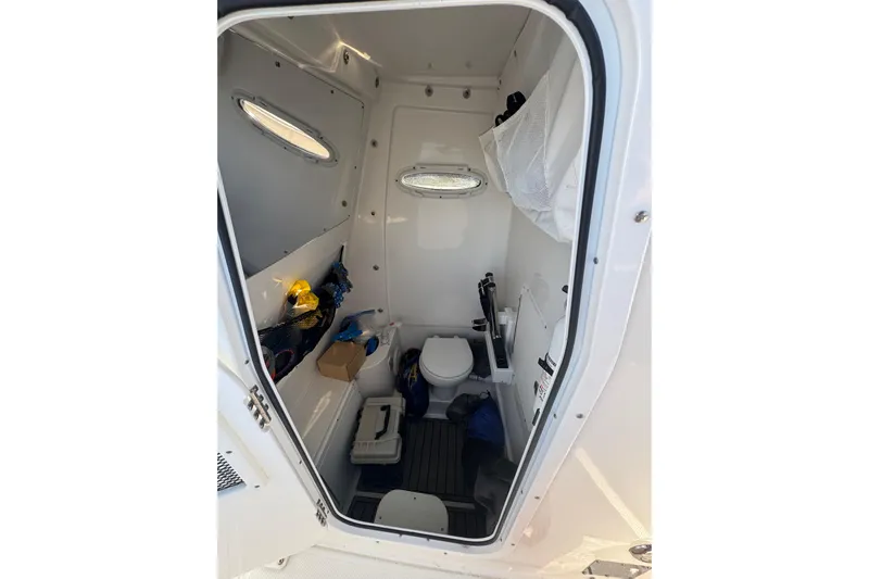  Yacht Photos Pics 2021 Sea Hunt Gamefish 30 Forward Seating boat interior with toilet and storage.