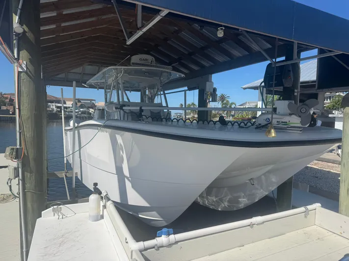  Yacht Photos Pics 2023 Invincible 33 Catamaran docked under a covered marina.