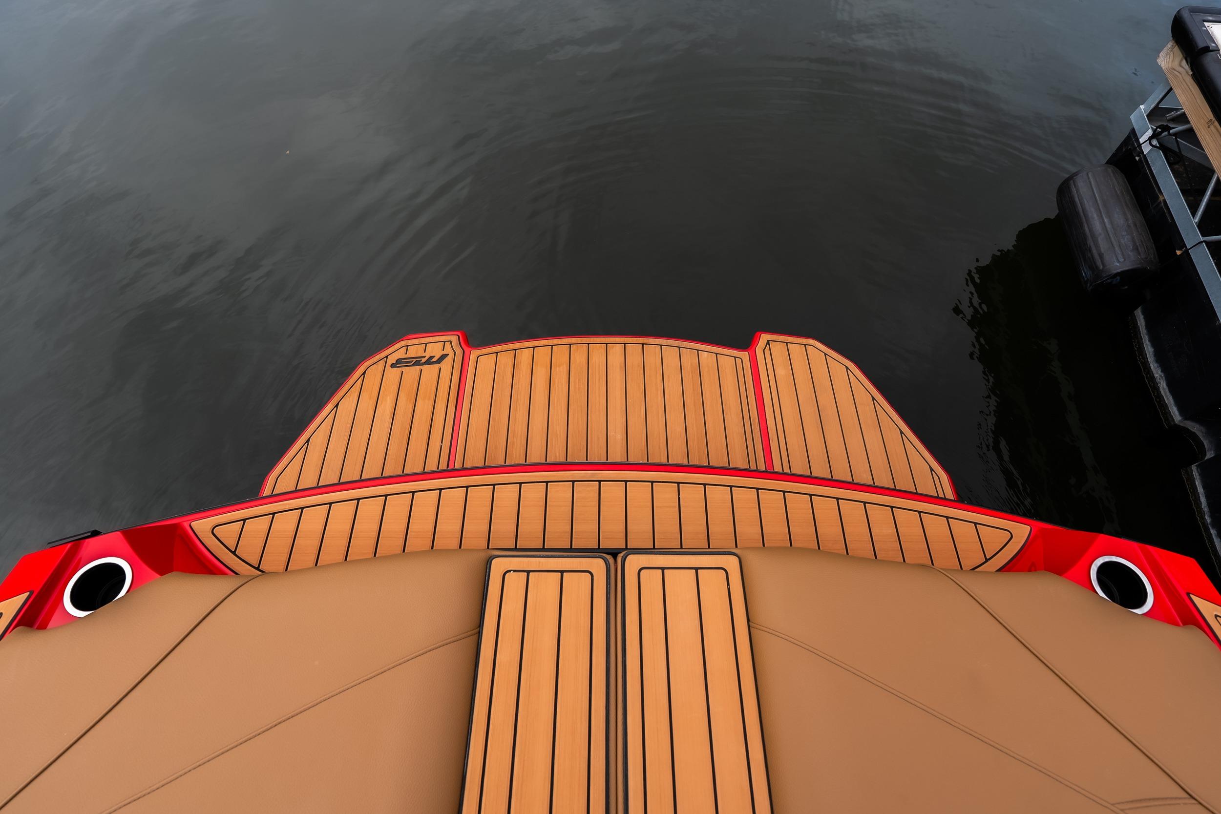 2026 MB B52 23 Classic boat with teak deck, docked on calm water.