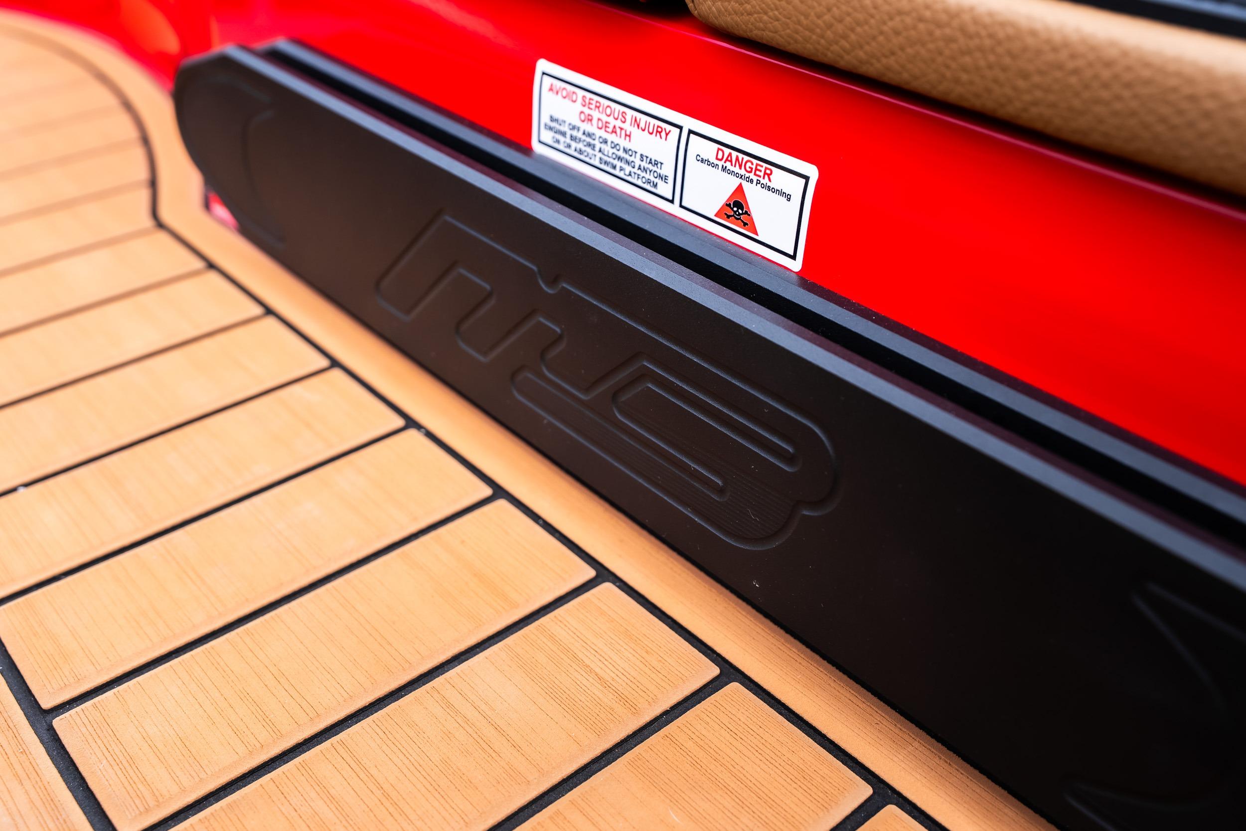 2026 MB B52 23 Classic boat deck with safety warning label.