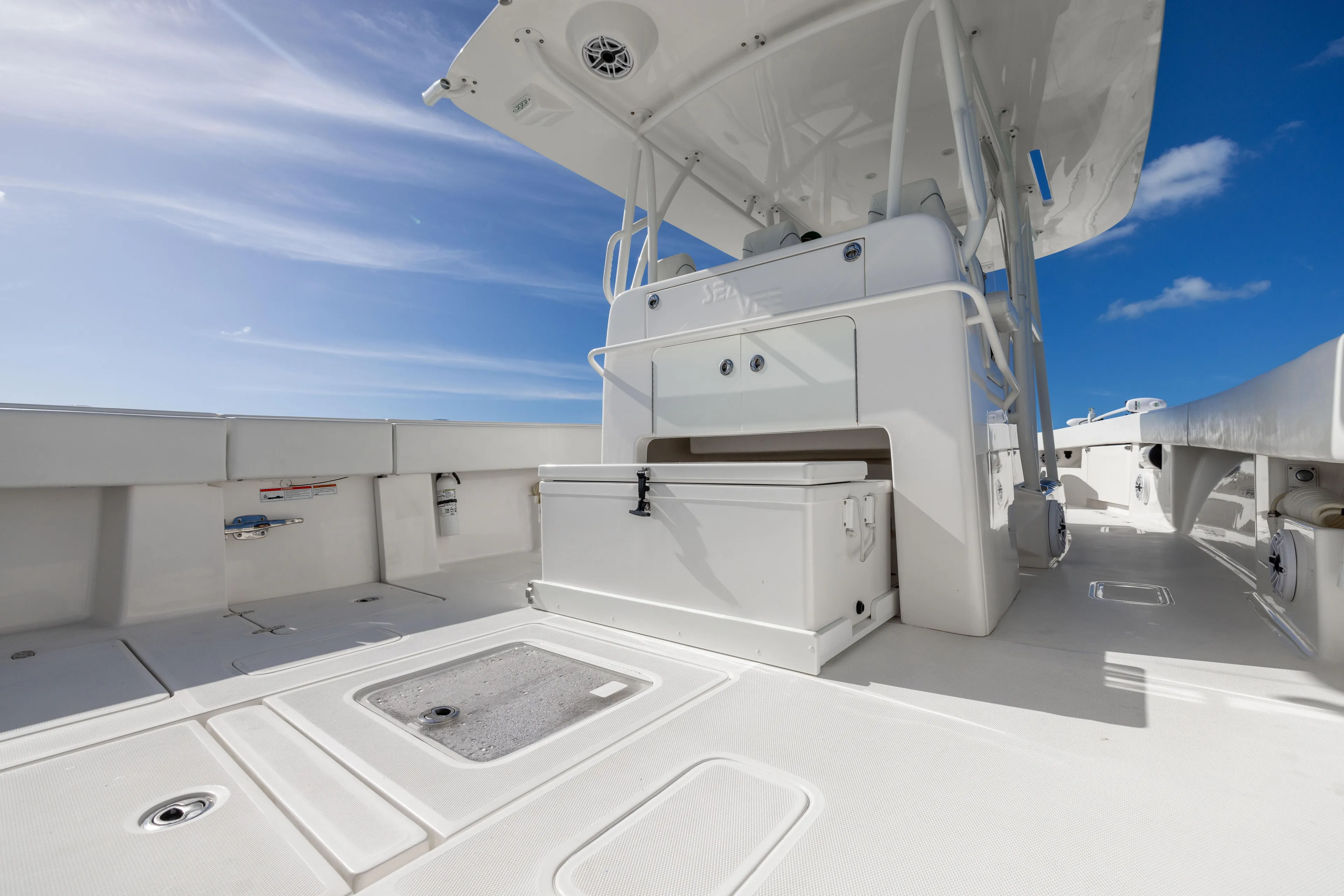  Yacht Photos Pics 2022 SeaVee 390Z boat deck with storage and seating under clear blue sky.
