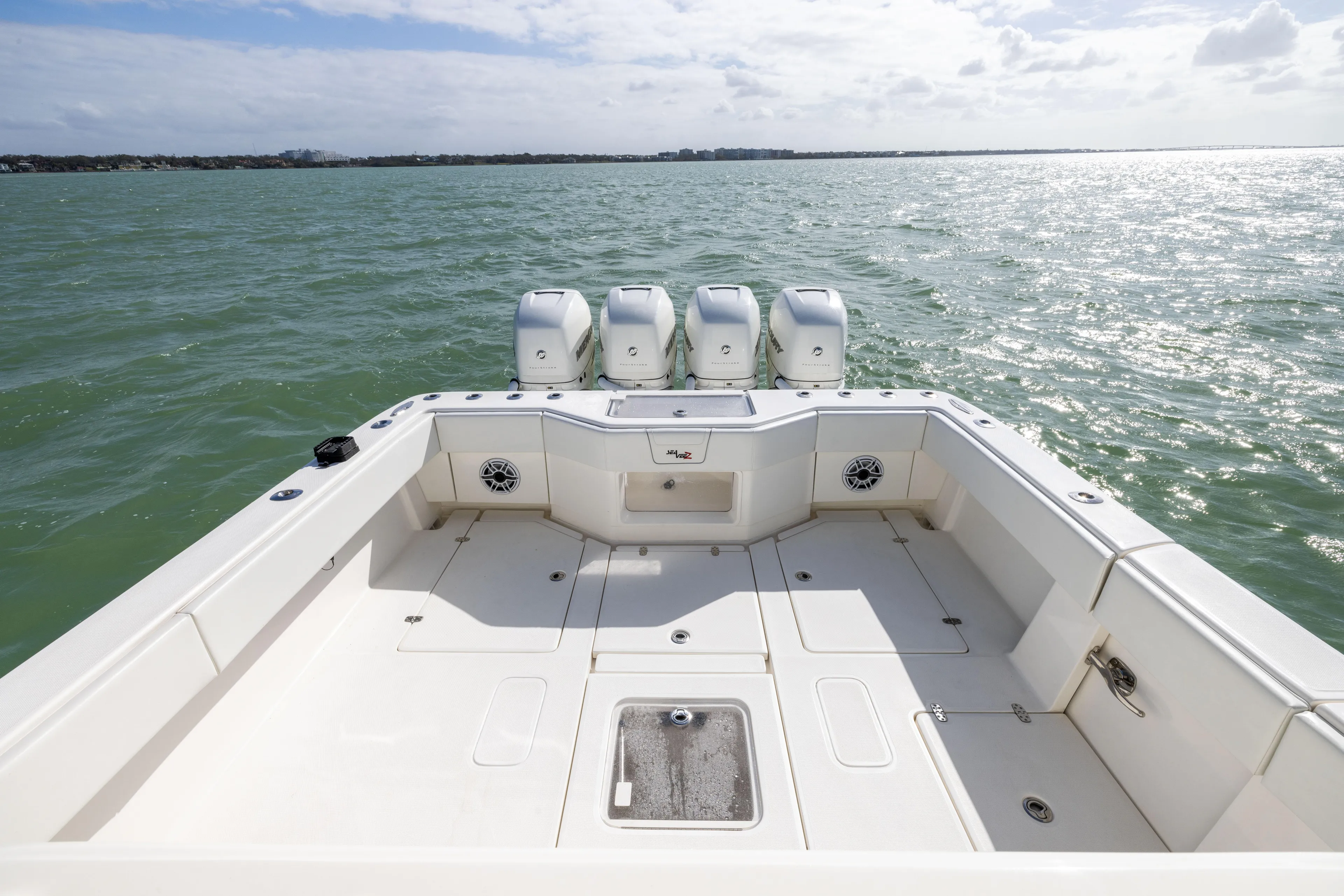  Yacht Photos Pics 2022 SeaVee 390Z boat deck with quad engines on open water.