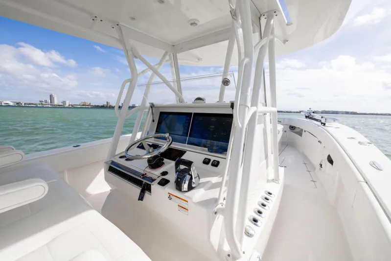  Yacht Photos Pics 2022 SeaVee 390Z boat helm with modern controls on open water.