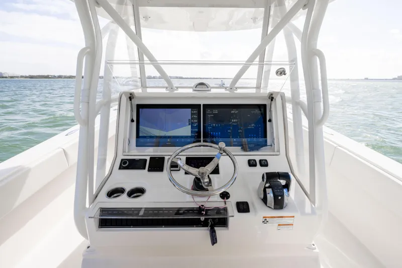 Yacht Photos Pics 2022 SeaVee 390Z boat dashboard with dual screens and steering wheel on open water.