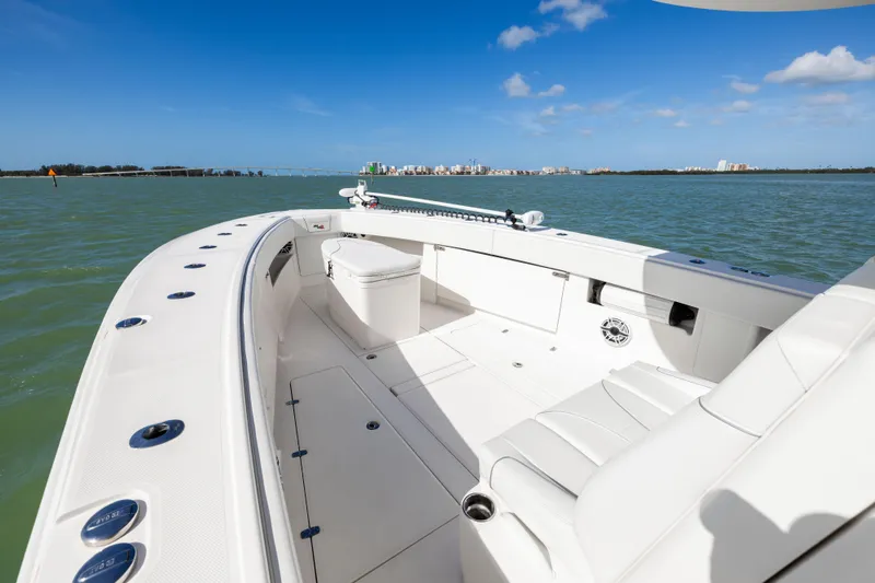  Yacht Photos Pics 2022 SeaVee 390Z boat on calm waters with city skyline in background.