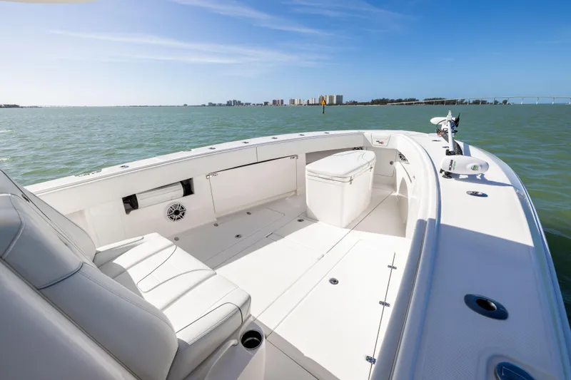  Yacht Photos Pics 2022 SeaVee 390Z boat interior with seating, on calm water, under clear blue sky.