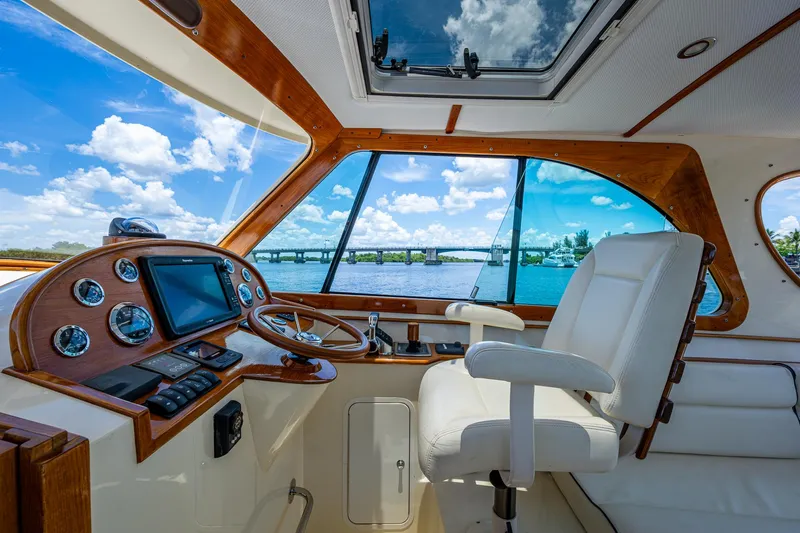 San Marco Yacht Photos Pics Interior of 2016 Hinckley Talaria 34 yacht with helm, steering wheel, and scenic water view.