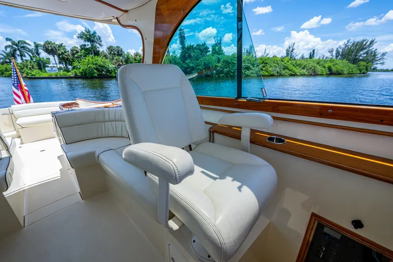 San Marco Yacht Photos Pics 2016 Hinckley Talaria 34 yacht interior with white seating, overlooking a scenic river view.