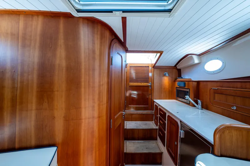 San Marco Yacht Photos Pics Interior of 2016 Hinckley Talaria 34 yacht with wooden cabinetry and modern kitchen amenities.