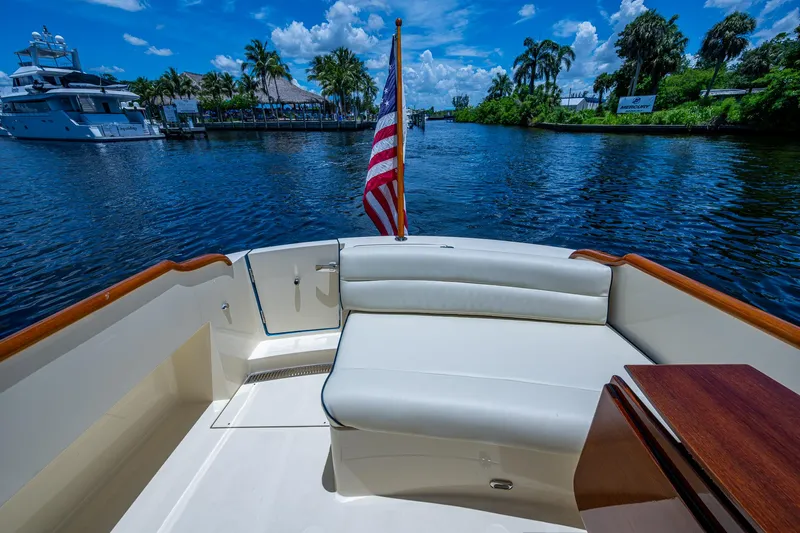 San Marco Yacht Photos Pics Hinckley Talaria 34 boat interior with American flag, scenic waterway view, 2016 model.