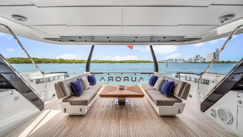 Aurora Yacht Photos Pics Luxurious 2022 Ferretti Yachts 1000 deck with elegant seating and scenic ocean view.