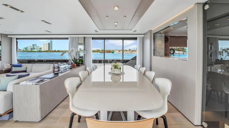 Aurora Yacht Photos Pics Luxurious interior of 2022 Ferretti Yachts 1000 with elegant dining area and scenic ocean views.