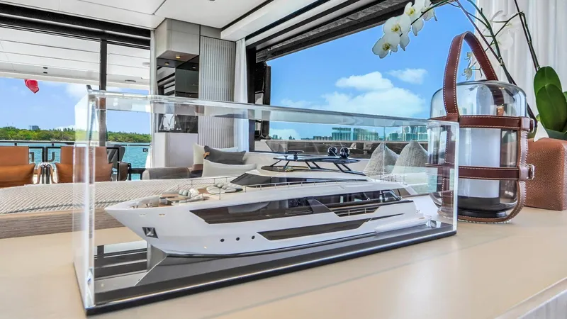 Aurora Yacht Photos Pics Model yacht display in luxury interior, Ferretti Yachts 1000, 2022, with scenic ocean view.