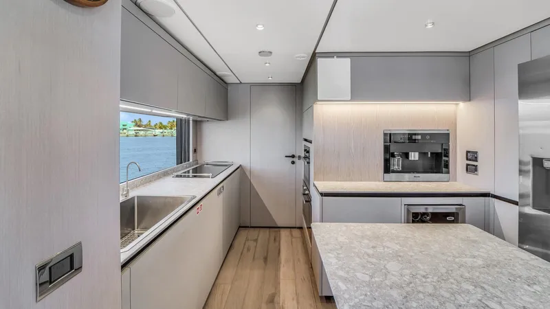Aurora Yacht Photos Pics Modern kitchen interior on 2022 Ferretti Yachts 1000, featuring sleek design and ocean view.