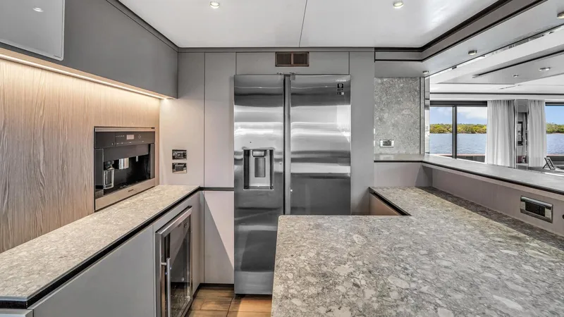 Aurora Yacht Photos Pics Luxurious kitchen interior of 2022 Ferretti Yachts 1000, featuring modern appliances and sleek design.