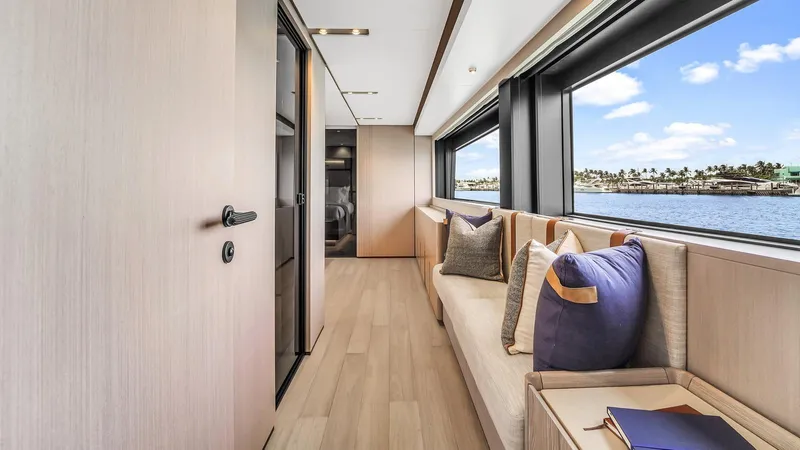 Aurora Yacht Photos Pics Luxurious interior of 2022 Ferretti Yachts 1000 with elegant seating and ocean view.