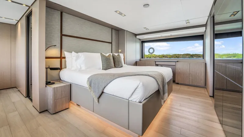 Aurora Yacht Photos Pics Luxurious bedroom interior of 2022 Ferretti Yachts 1000 with modern design and large window view.